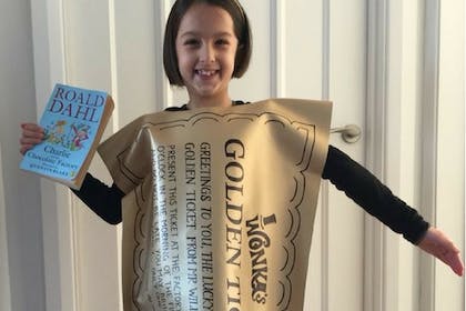 little girl dressed as roald dahl golden ticket - charlie and the chocolate factory