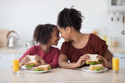Mum and daughter eating sandwiches