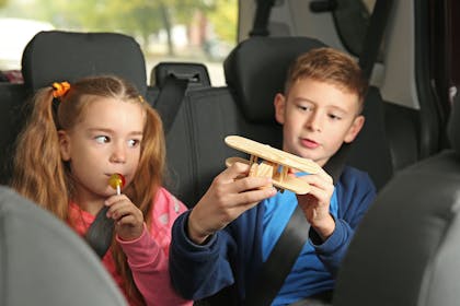 Kids playing in the backseat of the car