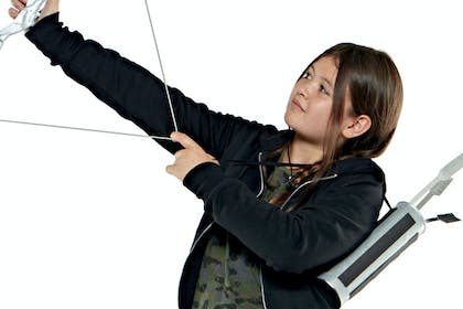 Girl dressed in Katniss Everdeen costume holding bow and arrow
